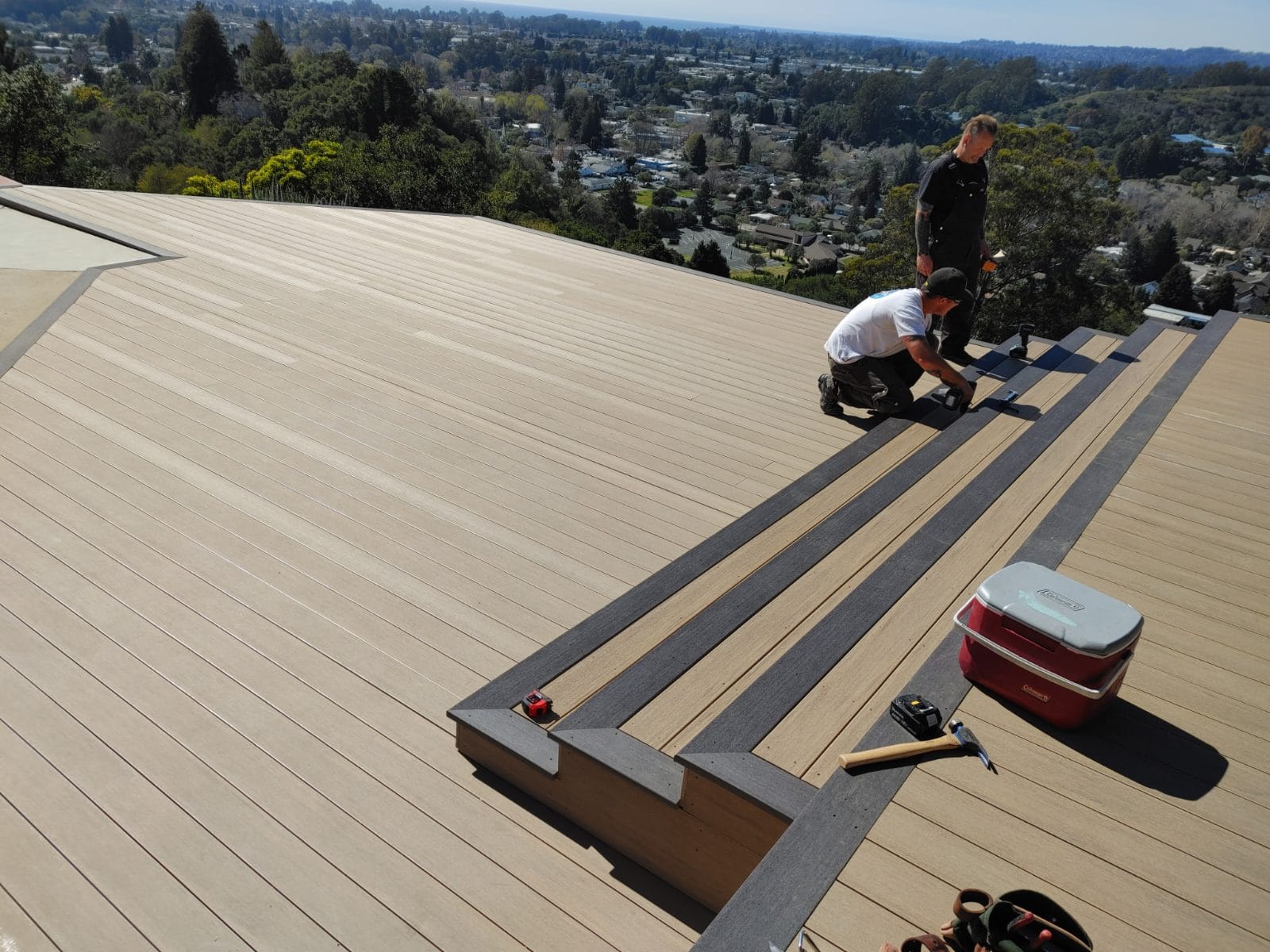 Crew installing composite decking with a contrasting border