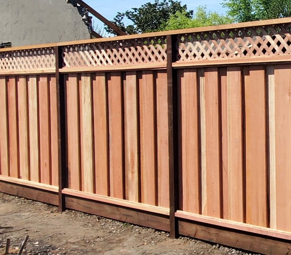 Board-on-board wood fence with a lattice top