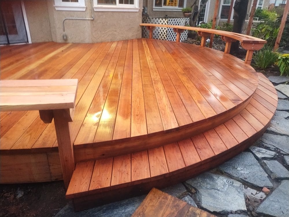 Custom curved redwood deck with a built-in bench