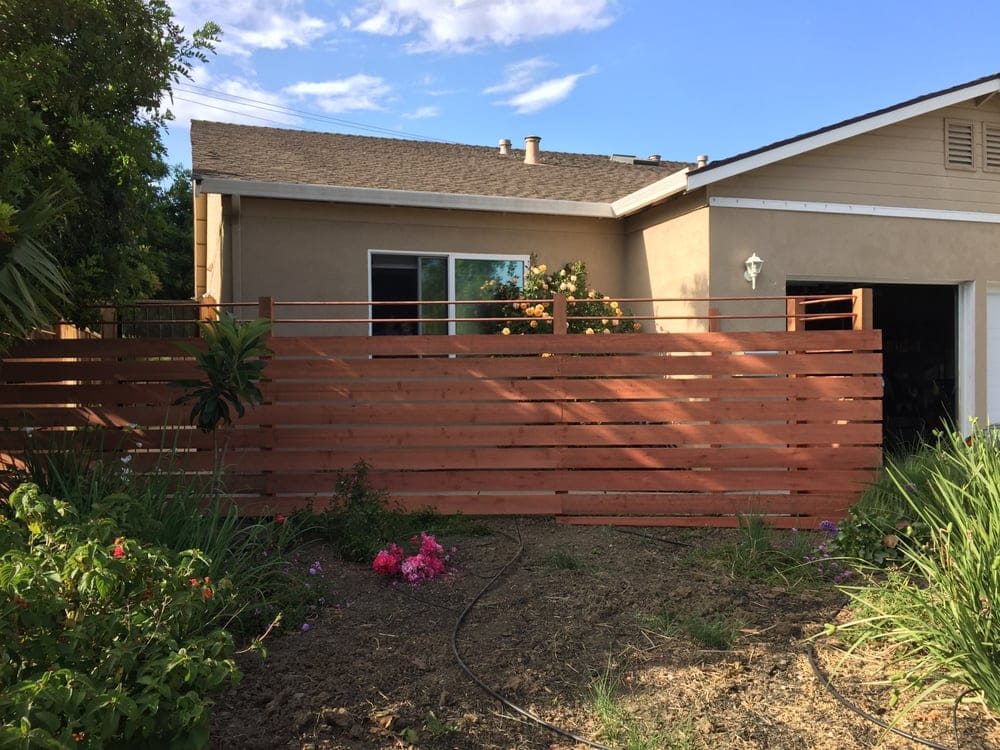 Horizontal wood fence across the front of a home