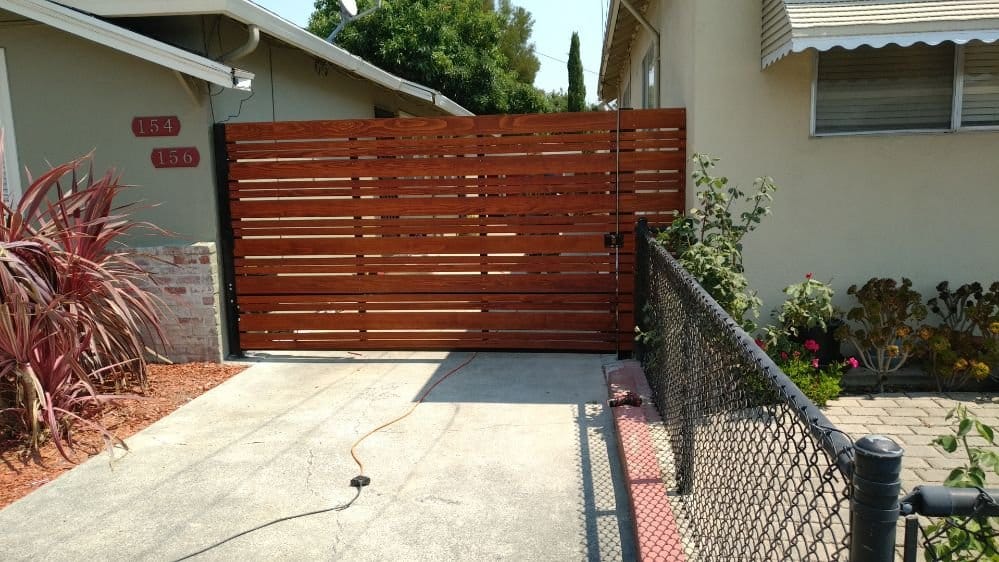 Automatic redwood driveway gate on a steel frame