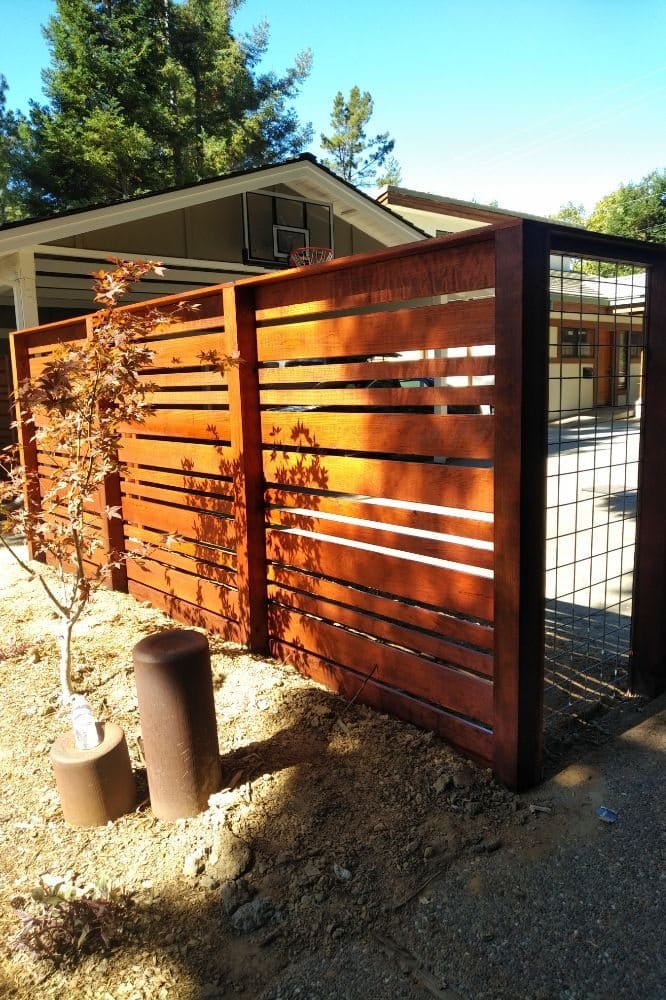 Horizontal wood fence with hog-wire panels