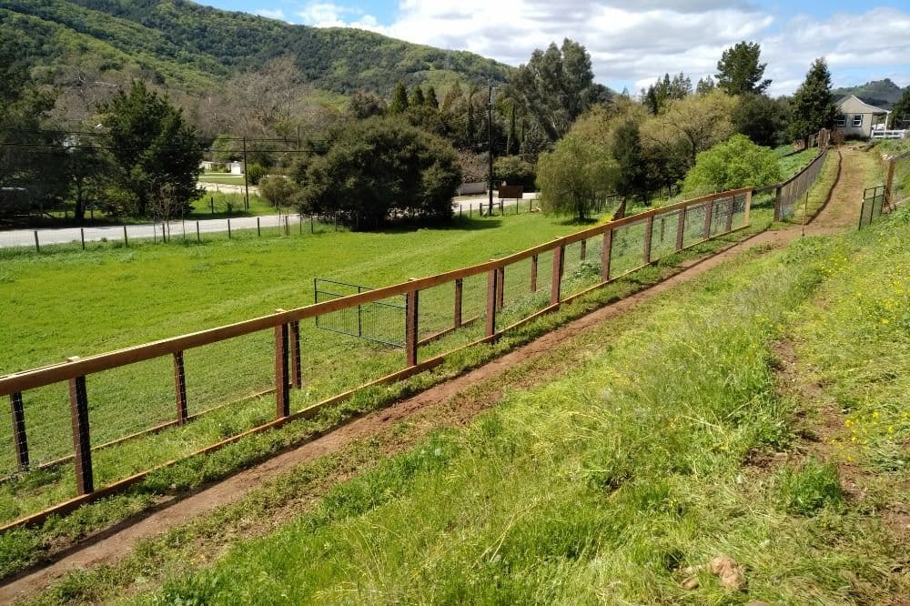 Welded-wire ranch fence across open land